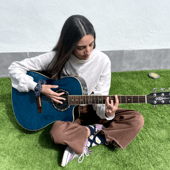 Noemi playing guitar